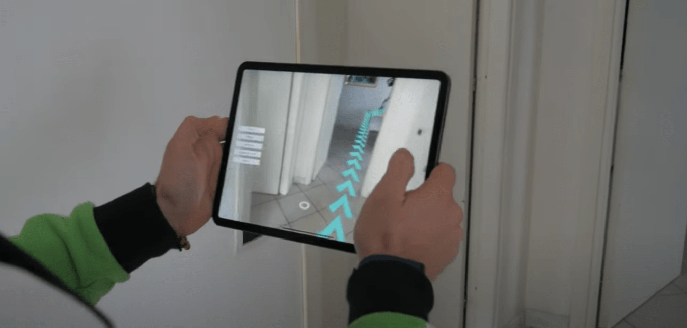 Employee navigating a warehouse with the help of an AR app